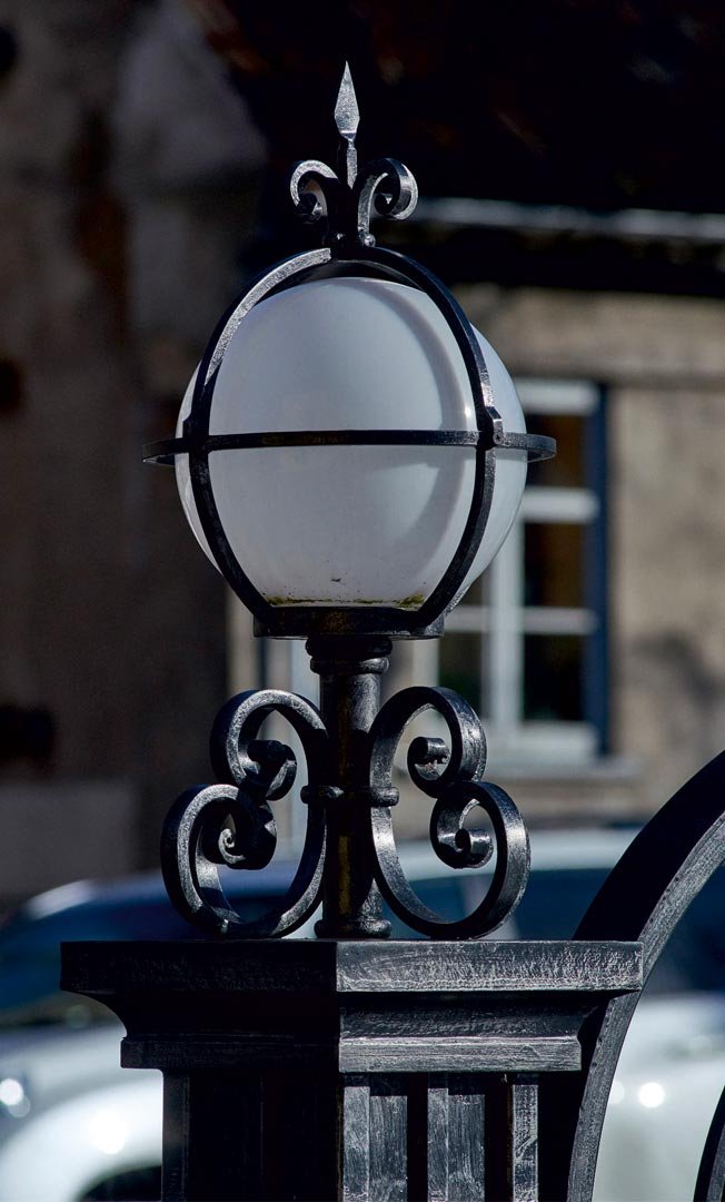 Forged metal, coated with hot zinc, painted.