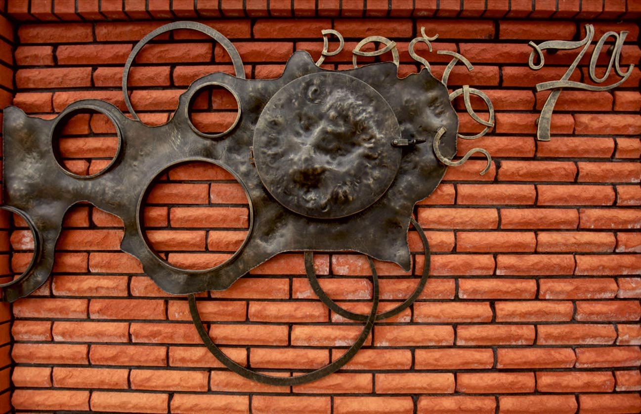 Forged metal, coated with hot zinc, painted