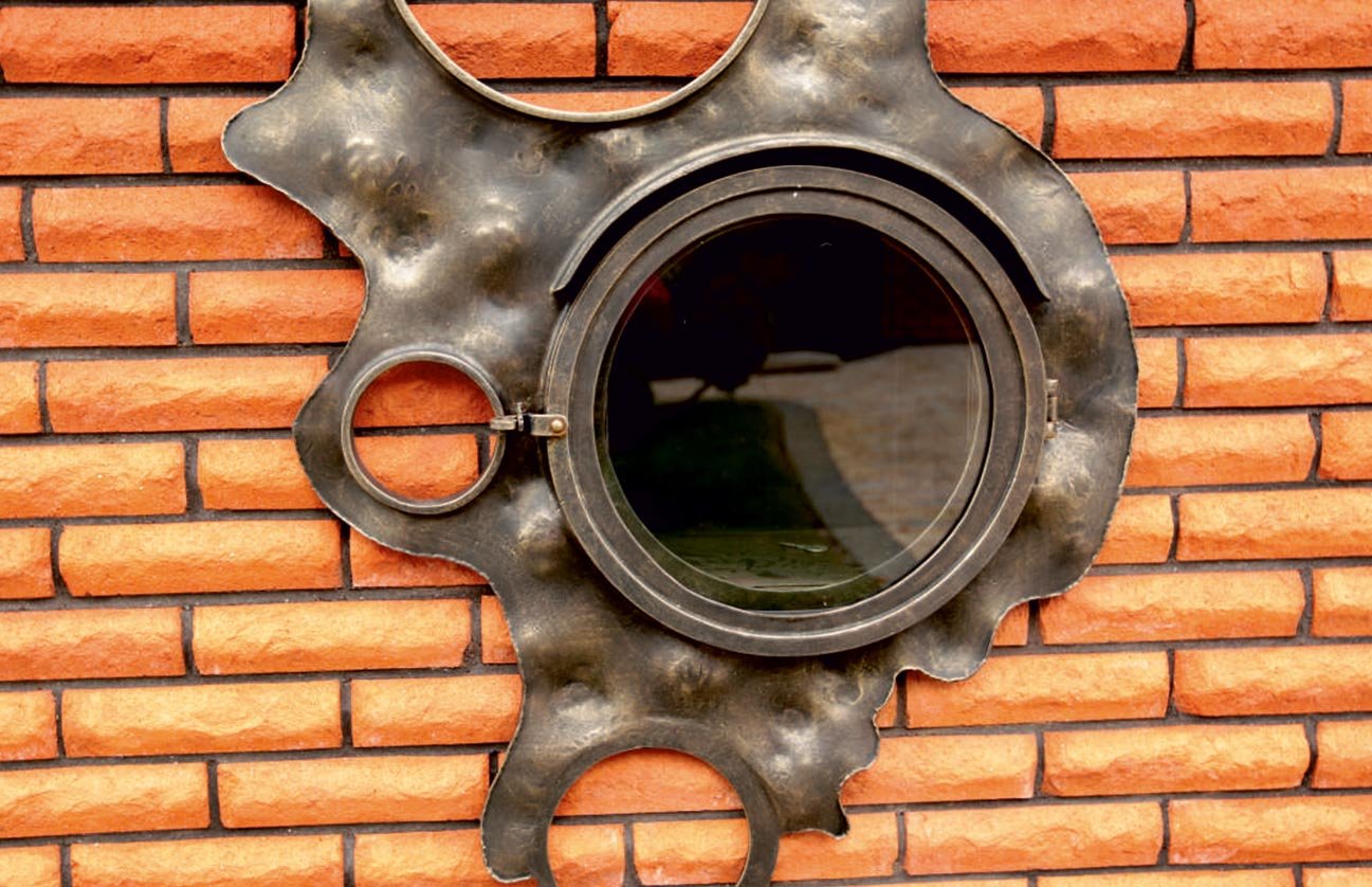 Forged metal, coated with hot zinc, painted