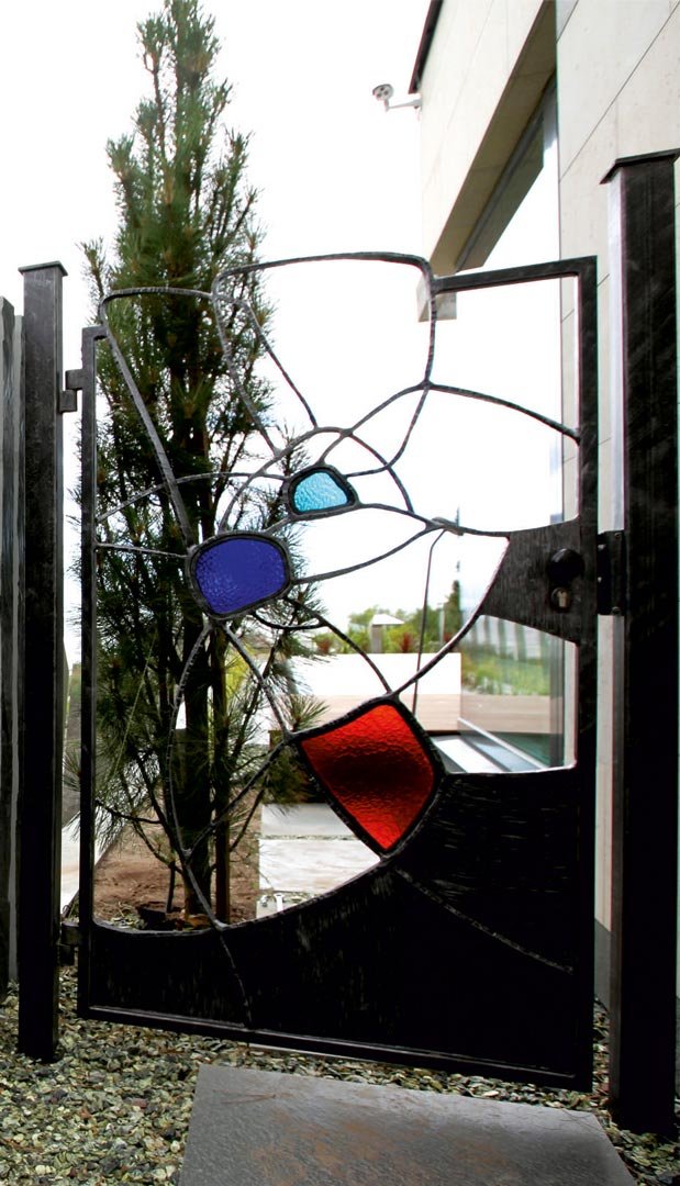 Forged metal gates, coated with hot zinc, painted, stained glass.