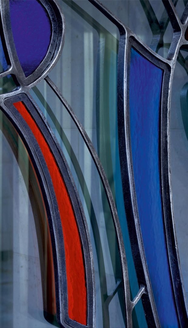 Forged metal gates, coated with hot zinc, painted, stained glass.